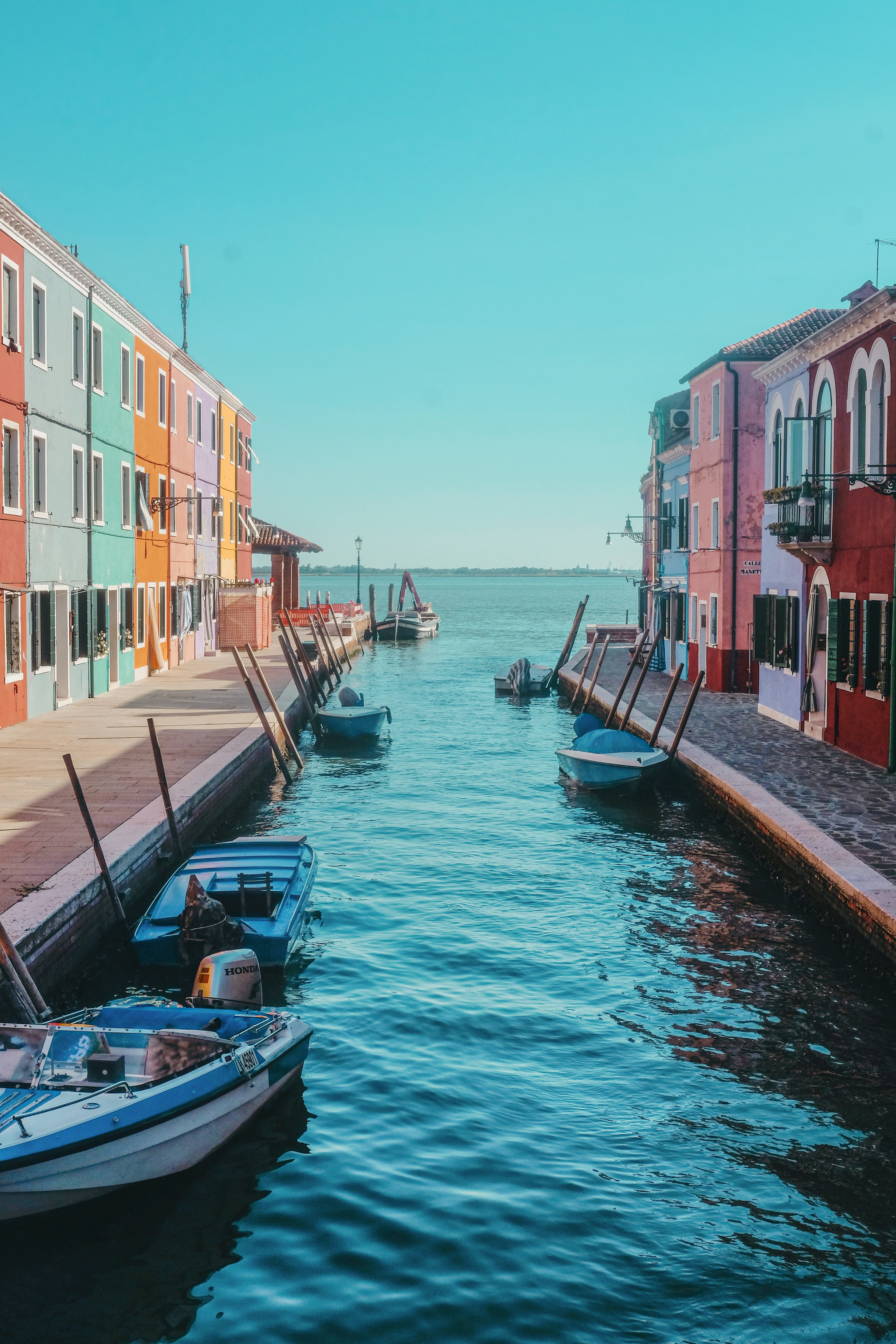 boat on dock near buildings during daytime